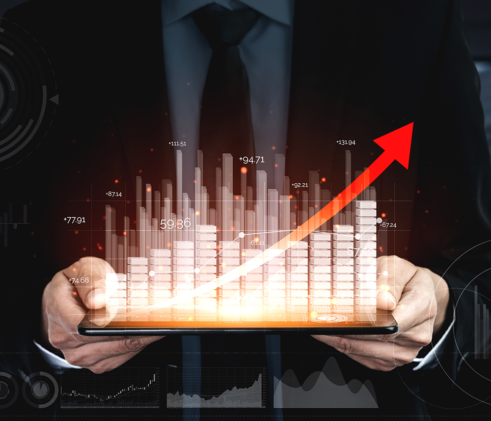 Hands holding an iPad with a digital graph and arrow showing the increasing in numbers.